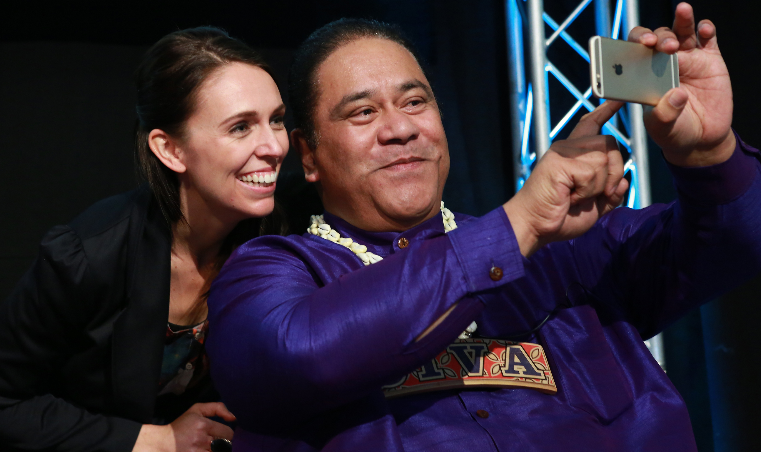 Musician Pati Umaga and then-Prime Minister Jacinda Ardern smile and pose for a selfie on Pati's phone
